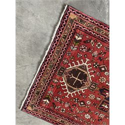 Persian Karajeh red ground runner, decorated with multiple stylised medallions and motifs