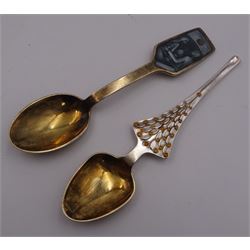 Two Danish silver-gilt year spoons by Georg Jensen, the first example decorated with enamel blue cornflower motif, dated 1972, in original pouch, the second example decorated with enamel pink briar rose motif, dated 1976, in original box, each impressed on underside RA AB, Sterling Denmark, and marked for Georg Jensen, together with two further examples by A.Michelson, the first with orange enamel fan design, dated 1965, impressed on underside A.Michelsen Sterling Danmark, TH, the second with enamel family scene, dated 1973, impressed on underside 925 S A.Michelsen Sterling Danmark, B Spang Olsen, approximate gross weight 6.11ozt (190.4 grams)