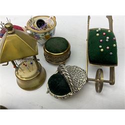 Collection of 19th century and later sewing accessories to include tape measure with cherub decoration, thimble case, pin cushion in the form of a shoe etc