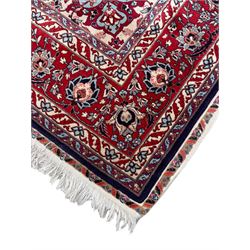 Persian Hamadan indigo ground rug, central floral crimson pole medallion surrounded by trailing foliate decoration and stylised plant motifs, the main guarded border with repeating stylised flower heads, densely knotted