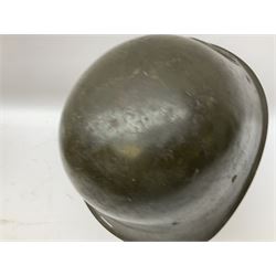 WW2 French M-26 Adrian Pattern Steel Helmet, original olive drab paint finish; flaming grenade badge to the front signifying issue to an Infantry regiment; original leather liner and leather chinstrap; and WW2 Dutch steel helmet with liner and chin strap (2)