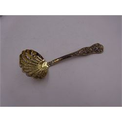 Victorian silver-gilt sugar sifting spoon, with gilded pierced shell shaped bowl, the handle decorated in relief with classical greek figures amongst fruiting vines, hallmarked Henry John Lias & James Wakely, London 1874,  L16cm, contained within tooled leather silk and velvet lined fitted case