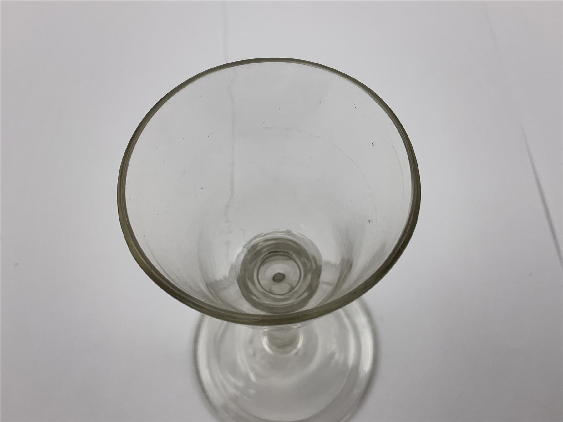 18th century wine glass, the trumpet shaped bowl upon tear drop stem and conical folded foot, H15.5cm, together with an 18th century cordial glass, the round funnel bowl on plain knopped stem and folded conical foot