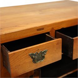 Mid-20th-century Chinese elm side cabinet, rectangular top above three drawers and a pair of panelled cupboard doors, mounted with traditional brass butterfly form handles and pierced circular lock plate 