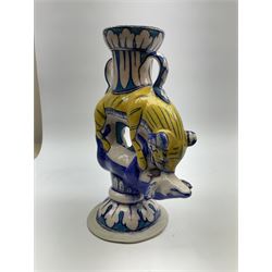 An early 20th century pottery twin handled vase, probably Persian, modelled as a tiger attacking an antelope and further detailed with leaf borders, H22.5cm. 