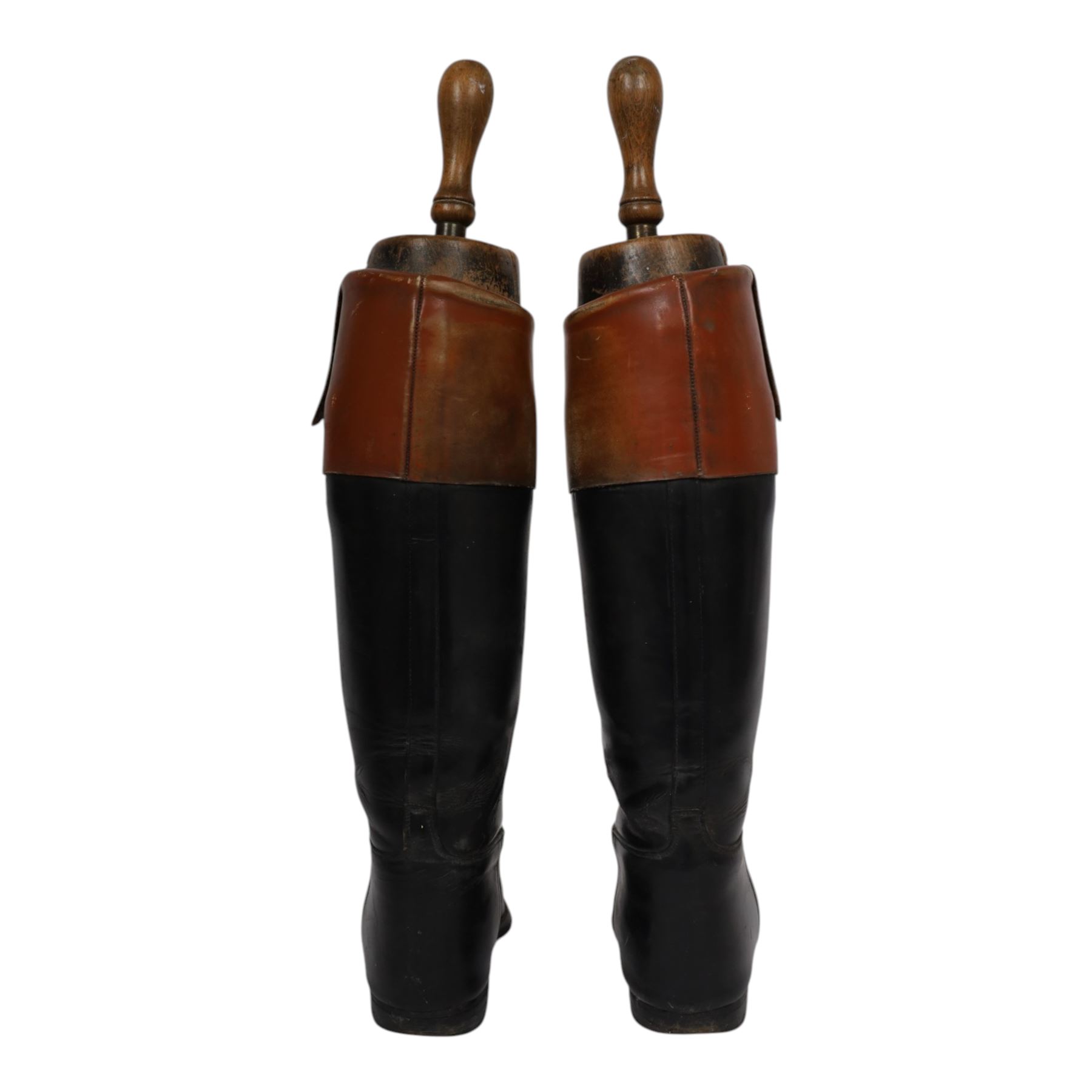 Pair of brown leather topped riding boots, with wooden shoe trees