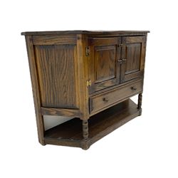 Traditional oak shaped front side cabinet, fitted with two cupboards and single drawer
