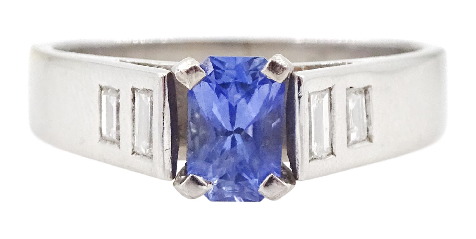 White gold sapphire and diamond ring, single stone radiant cut sapphire of approx 0.65 carat, with two baguette cut diamonds set either side, hallmarked 9ct