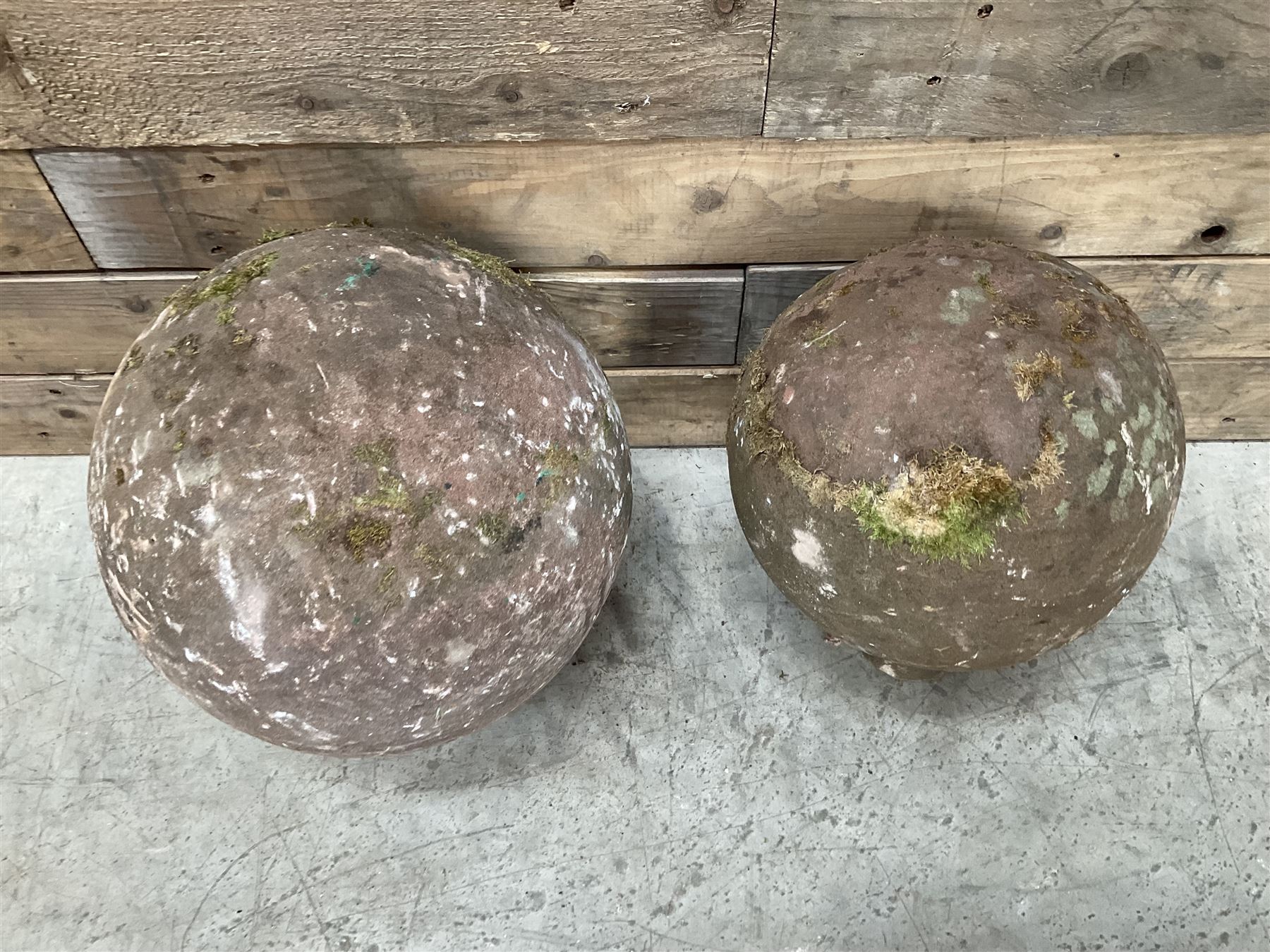 Two spherical stone gate post finials