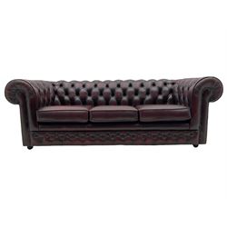 Chesterfield three seat sofa, upholstered in deeply buttoned oxblood leather