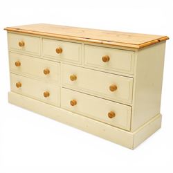 20th century painted pine chest, rectangular top over an assortment of seven drawers, on skirted base
