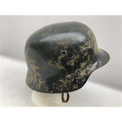 WW2 German steel helmet painted in undecaled Luftwaffe bluey grey with leather liner and chin strap stamped '58', the skirt impressed '1250'