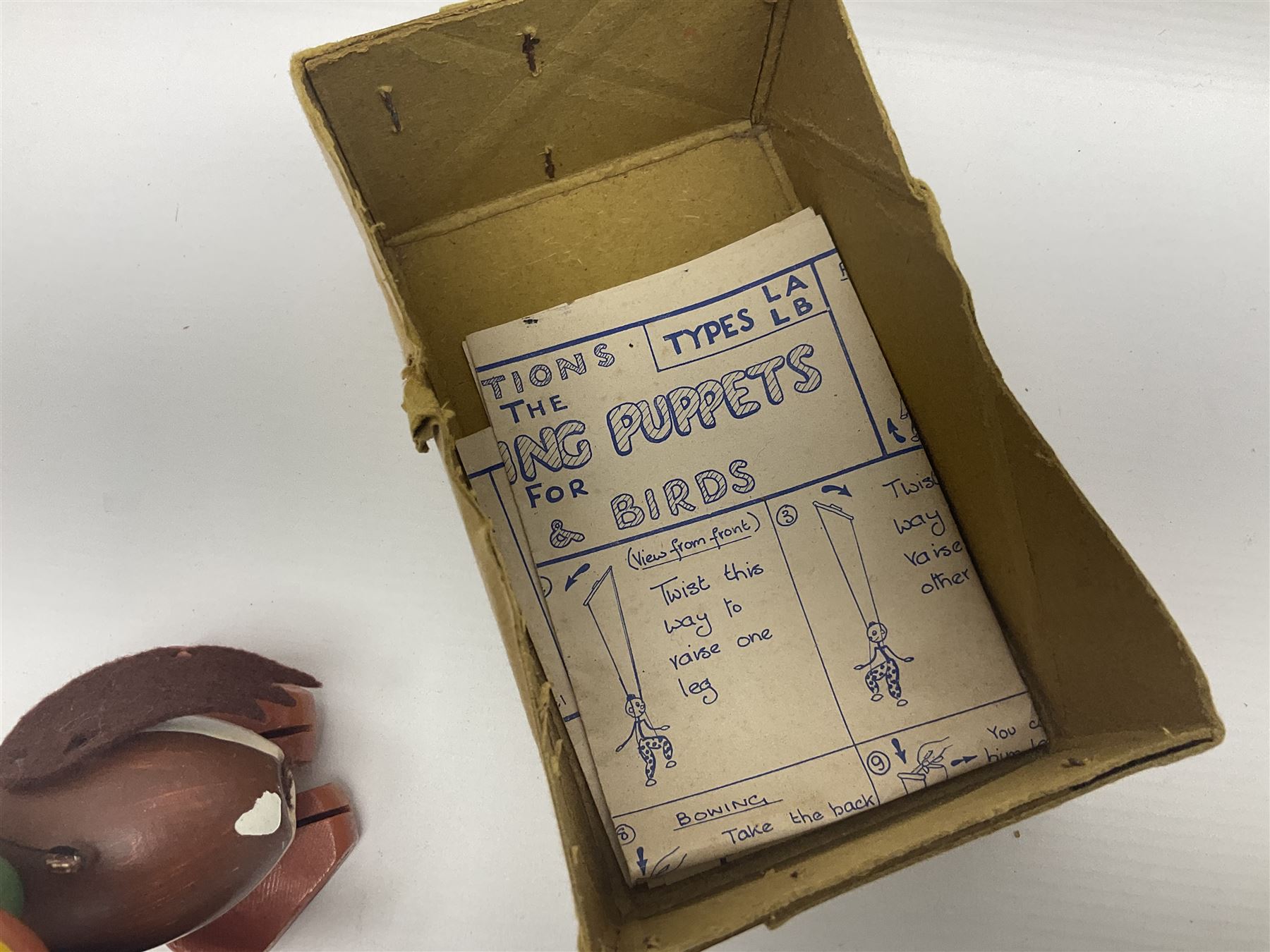 Pelham Puppet - three puppets comprising a painted wooden duck with felt mouth and wings with metal joints H12cm, in original box and instructions; and two further examples Type A cat with a hollow body H12cm, and a boy H23cm (3) 