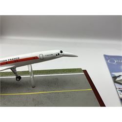 Danbury Mint 'The Ultimate James Bond Collection' comprising stamps and coins housed in a display case, 'Concorde Queen of the Skies' sculpture, stamps, medallion display and 2020 'Centenary of the Unknown Warrior' five pound coin cover in Harrington and Byrne folder