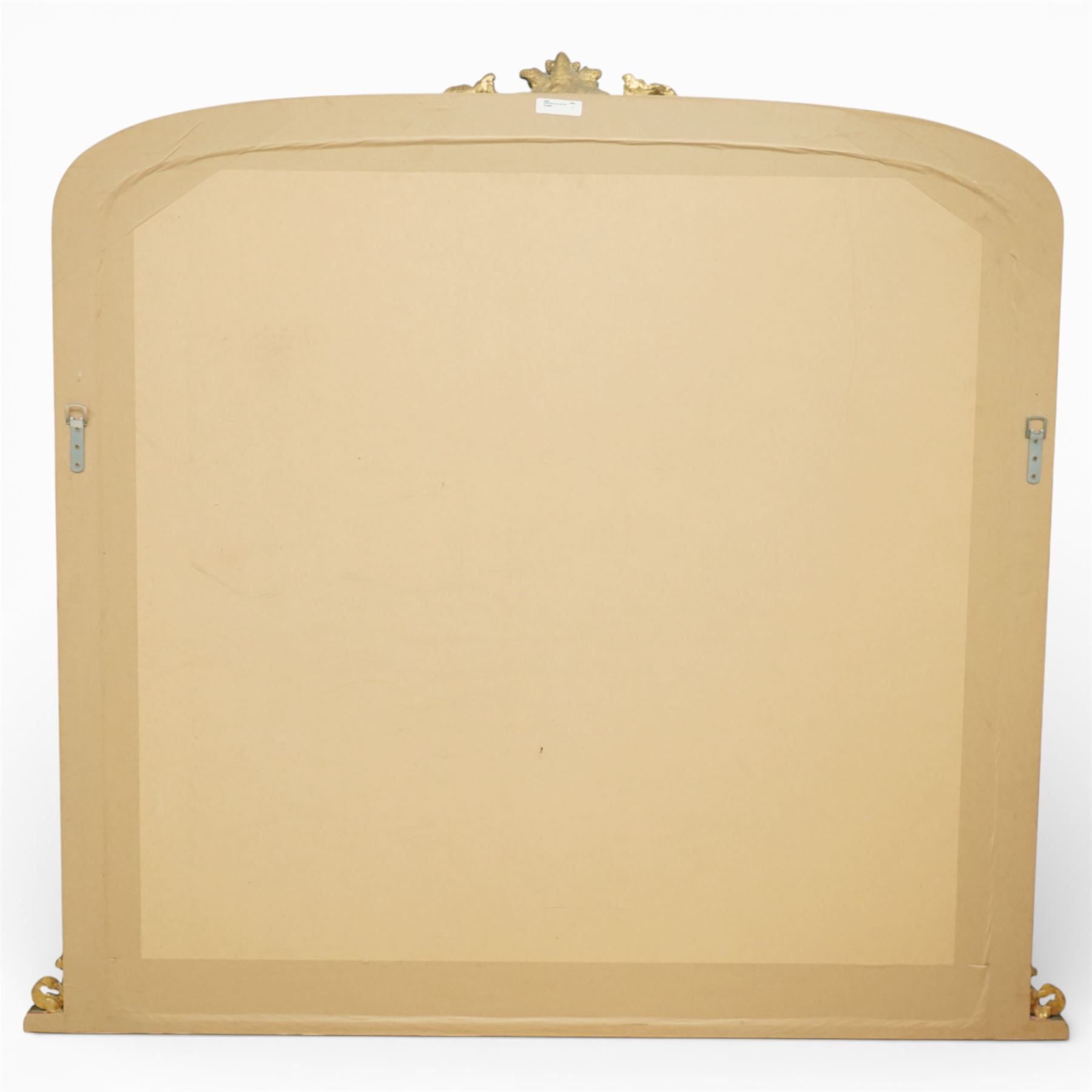 Regency style gilt overmantle mirror, arched rectangular frame with moulded surround, surmounted by a central anthemion and scrolling foliate crest, the frame enriched with beaded and foliate mouldings, the lower corners with applied scroll terminals, enclosing a single rectangular mirror plate