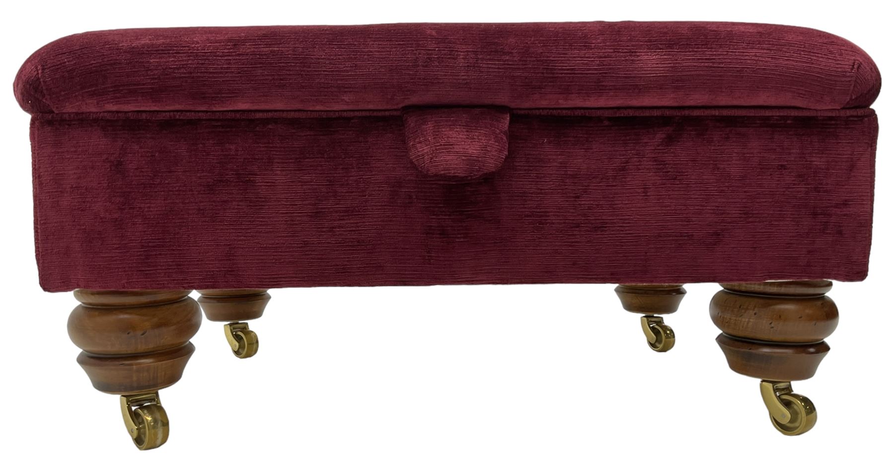 Duresta - traditional shape armchair upholstered in burgundy red velvet, on square tapering front supports (W88cm, H85cm, D103cm); together with a matching rectangular footstool with hinged seat, on turned feet with brass castors (73cm x 54cm, H38cm)