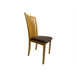 Skovby - 'SM32' late 20th century beech circular extending dining table circular segmented top turning to activate a patented spring loaded triple leaf extension stored within the cylindrical column base (Extended diameter 146cm); and set of four chairs (Width 47cm, Depth 56cm, Height 95cm, Seat height 47cm)