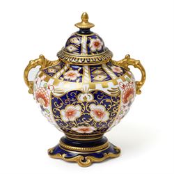Mixed Royal Crown Derby Imari 6299 pattern wares, including a pair of vases, H8cm; covered twin handled urn, H14cm; slender vase, H19cm, and a pattern 2451 plate, D23cm (5)