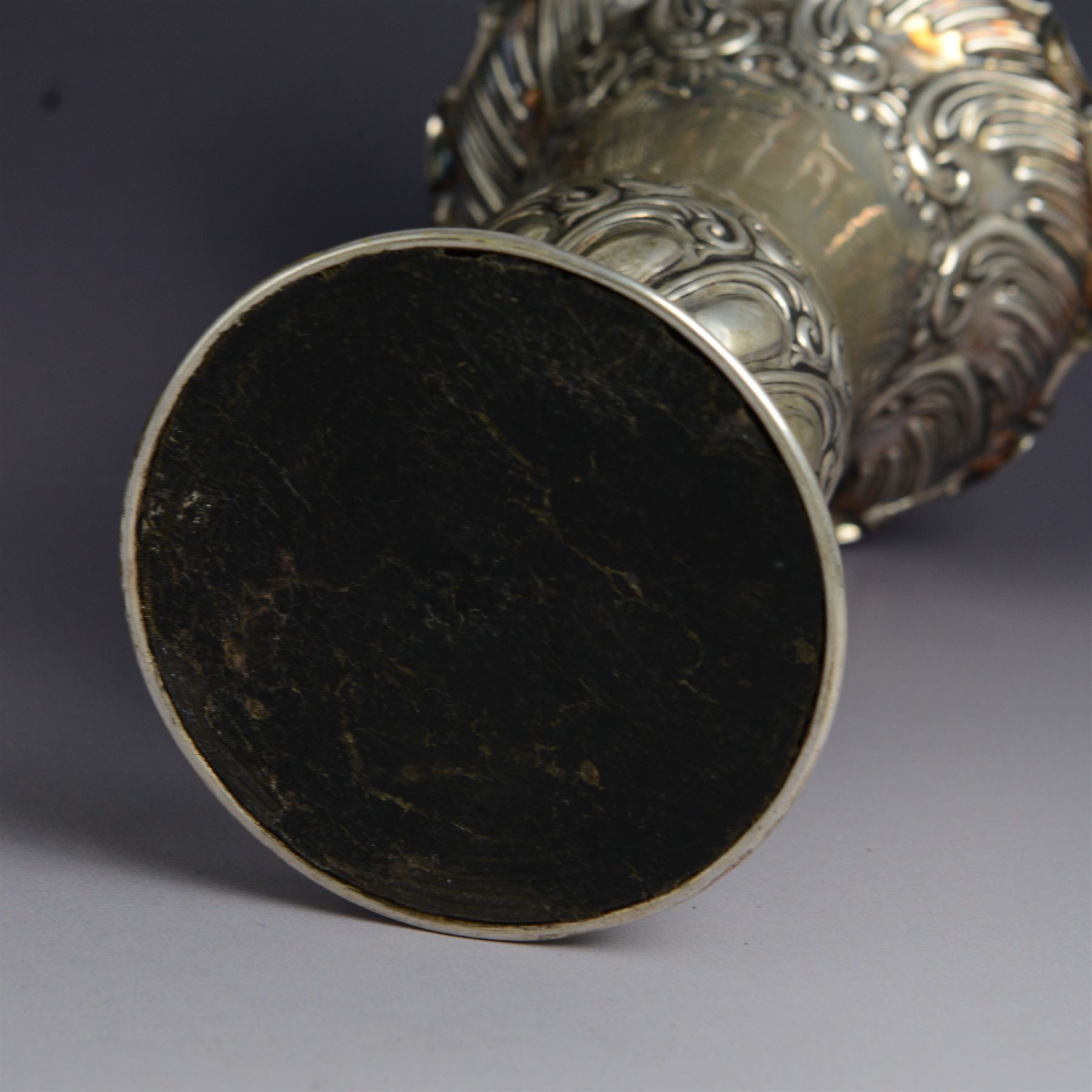 Three late 19th century/early 20th century silver vases, of trumpet form, all embossed with floral and foliate decoration, one example with weighted base, all hallmarked, tallest H18cm