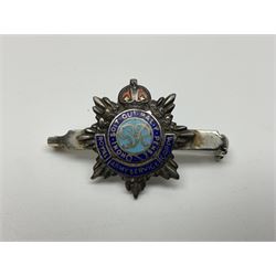 Popski's Private Army sterling silver cap badge; and two silver sweetheart brooches for Highland Light Infantry as a rifle and silver gilt Glengarry badge and Army Service Corps with blue enamel; and another silver badge (4)