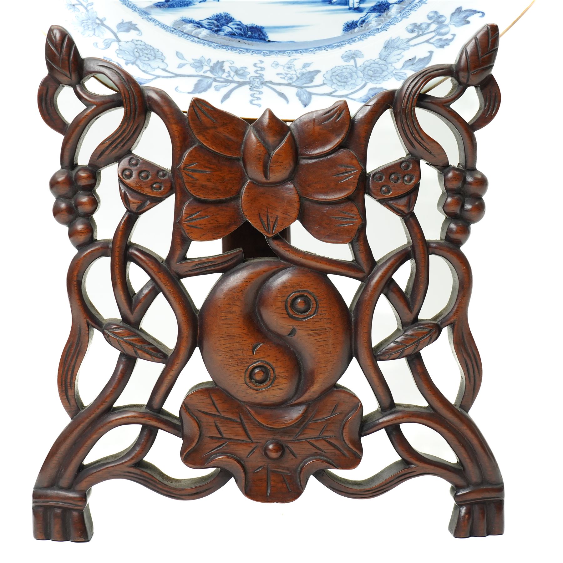 18th century Chinese plate of octagonal design decorated in blue and white with figures by a river with buildings etc W30cm on a 19th century hardwood stand