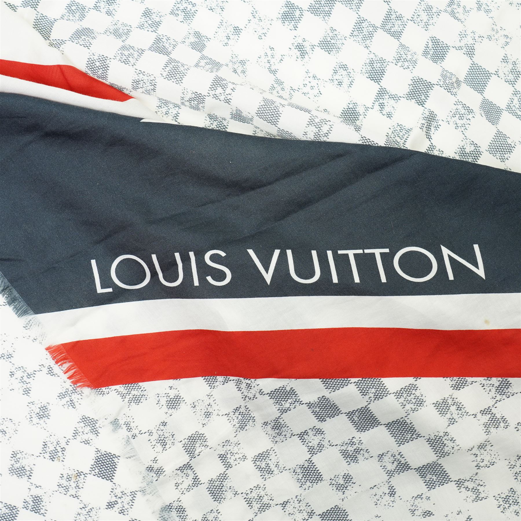 Louis Vuitton America’s Cup stole, the Damier-pattern ground with navy, red and white graphic panels, large ‘35’ motif and Louis Vuitton and America’s Cup lettering, fringed ends, label stamped Louis Vuitton Paris, 65% cotton and 35% silk, made in Italy, 201cm x 66cm