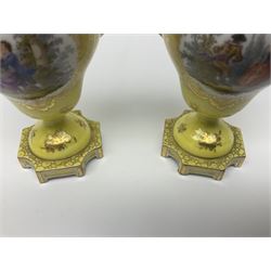 Pair of early 20th century Dresden vases with cover, of baluster form, decorated with figural panels within ornate gilt borders upon a yellow ground, with twin gilt goat mask handles, H16.5cm