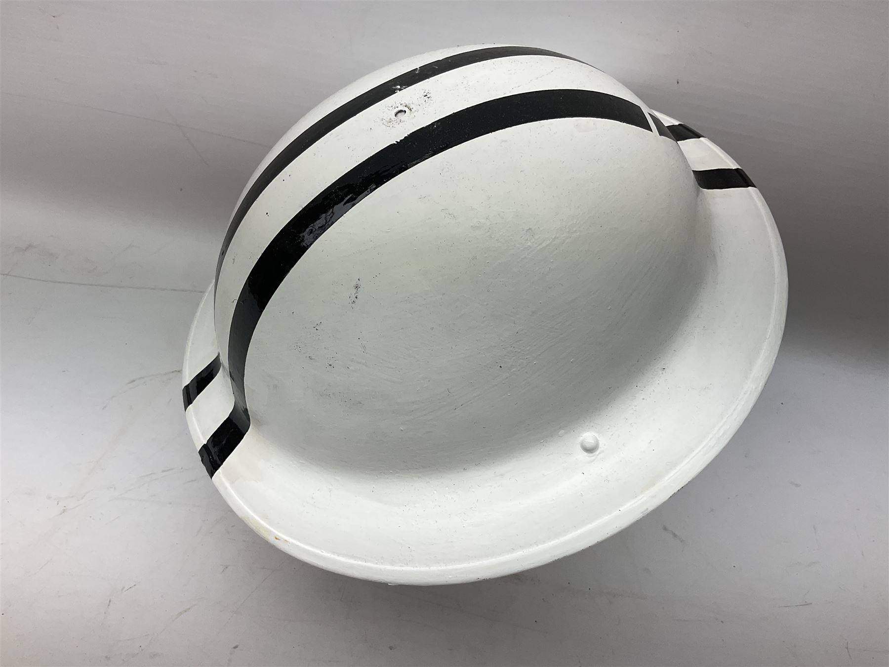 WW2 Home Front 'Police' black painted steel helmet with original liner and webbing chin strap, impressed R.O. Co. 1/1939; and re-painted shell only for WW2 Wardens steel helmet impressed AMC II 1941 C676 (2)