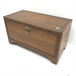 Early 20th century camphor wood chest, single hinged lid with carved foliage detailing, ogee bracket supports, W102cm, H56cm, D51cm