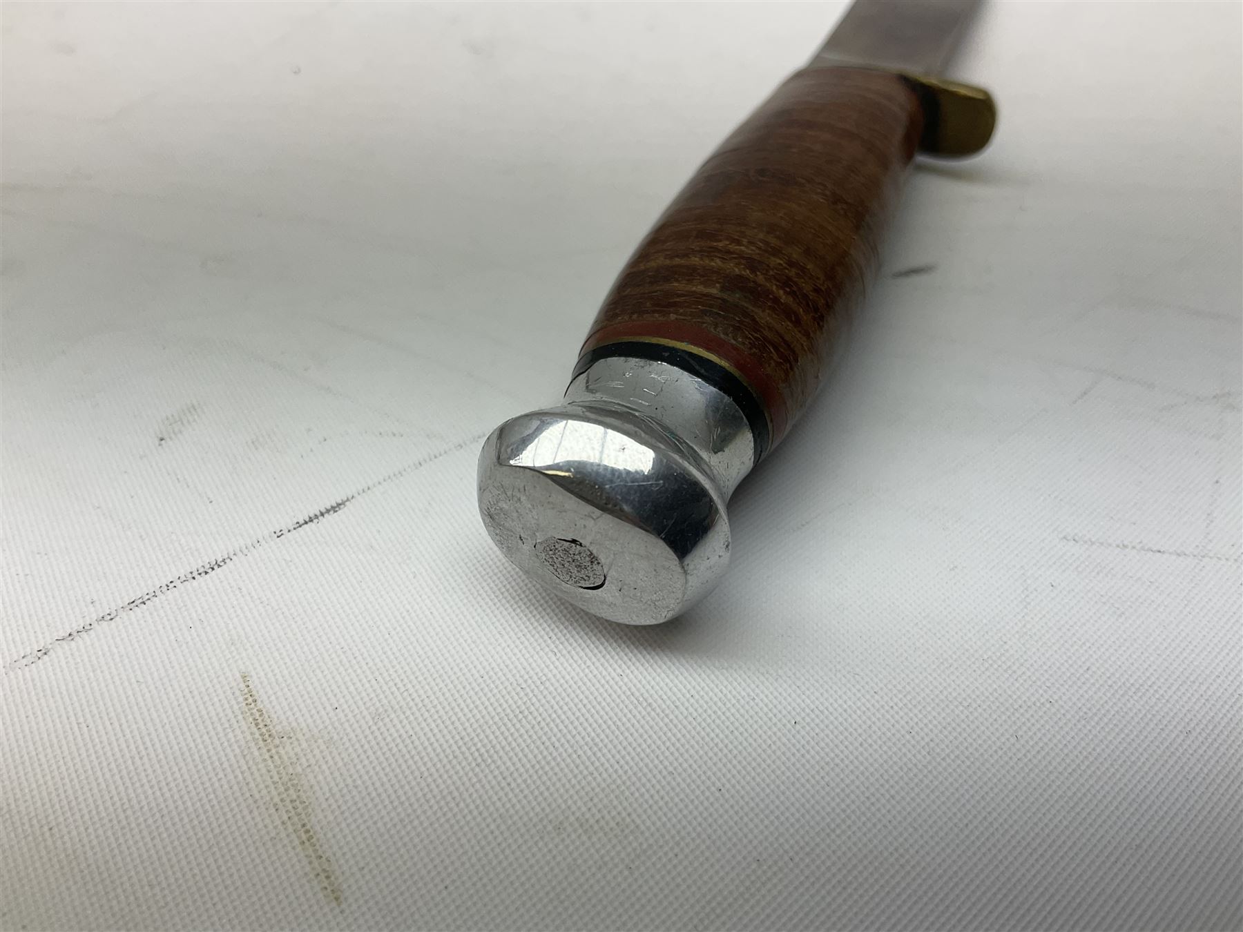 Graduated set of three Bowie knives by J. Nowill & Sons Sheffield England Est. AD1700, each with steel blade, brass cross-piece, stacked leather type grip and alloy pommel; largest blade 13cm and smallest 7.5cm; each in leather sheath (3)