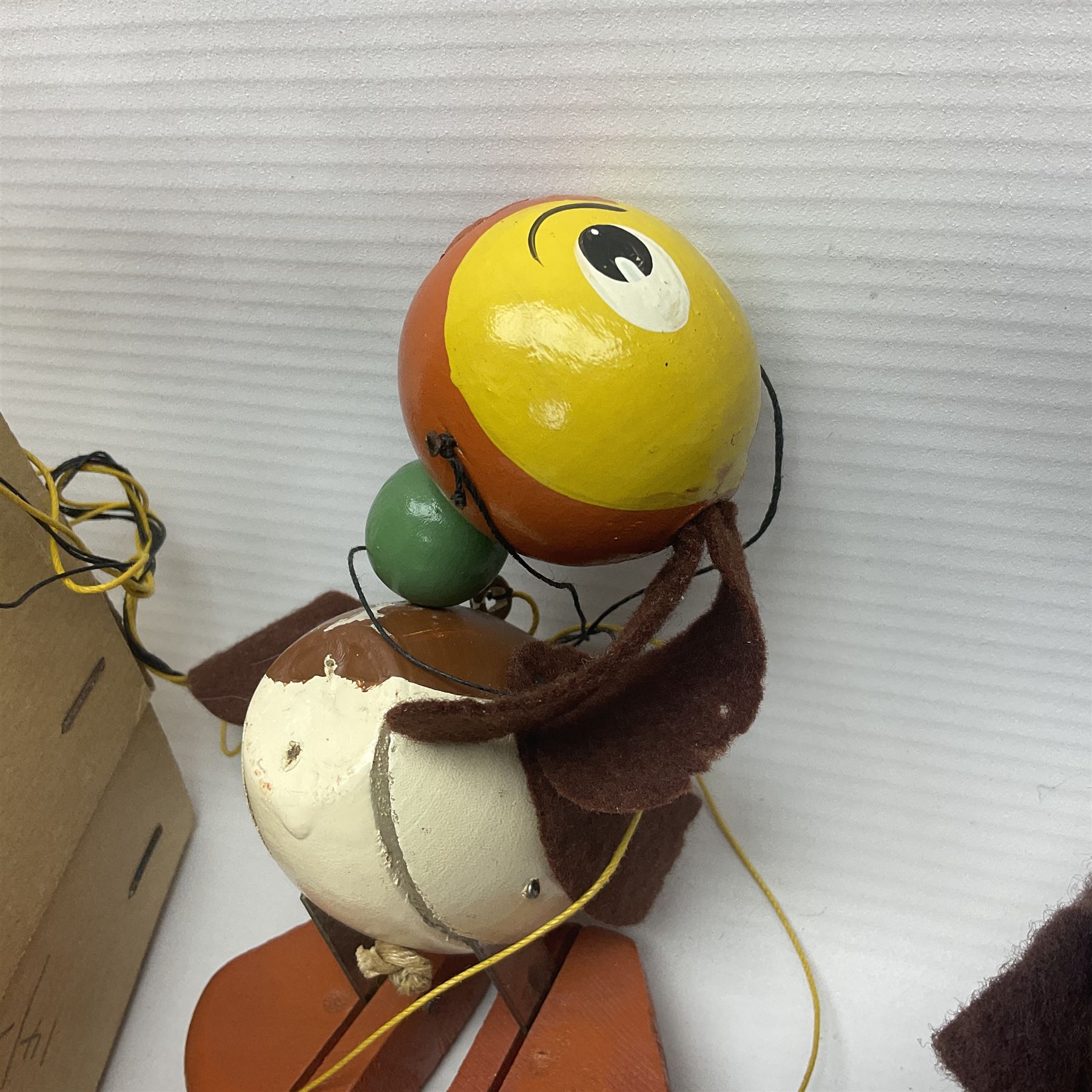 Pelham Puppet - three puppets comprising a painted wooden duck with felt mouth and wings with metal joints H12cm, in original box and instructions; and two further examples Type A cat with a hollow body H12cm, and a boy H23cm (3) 