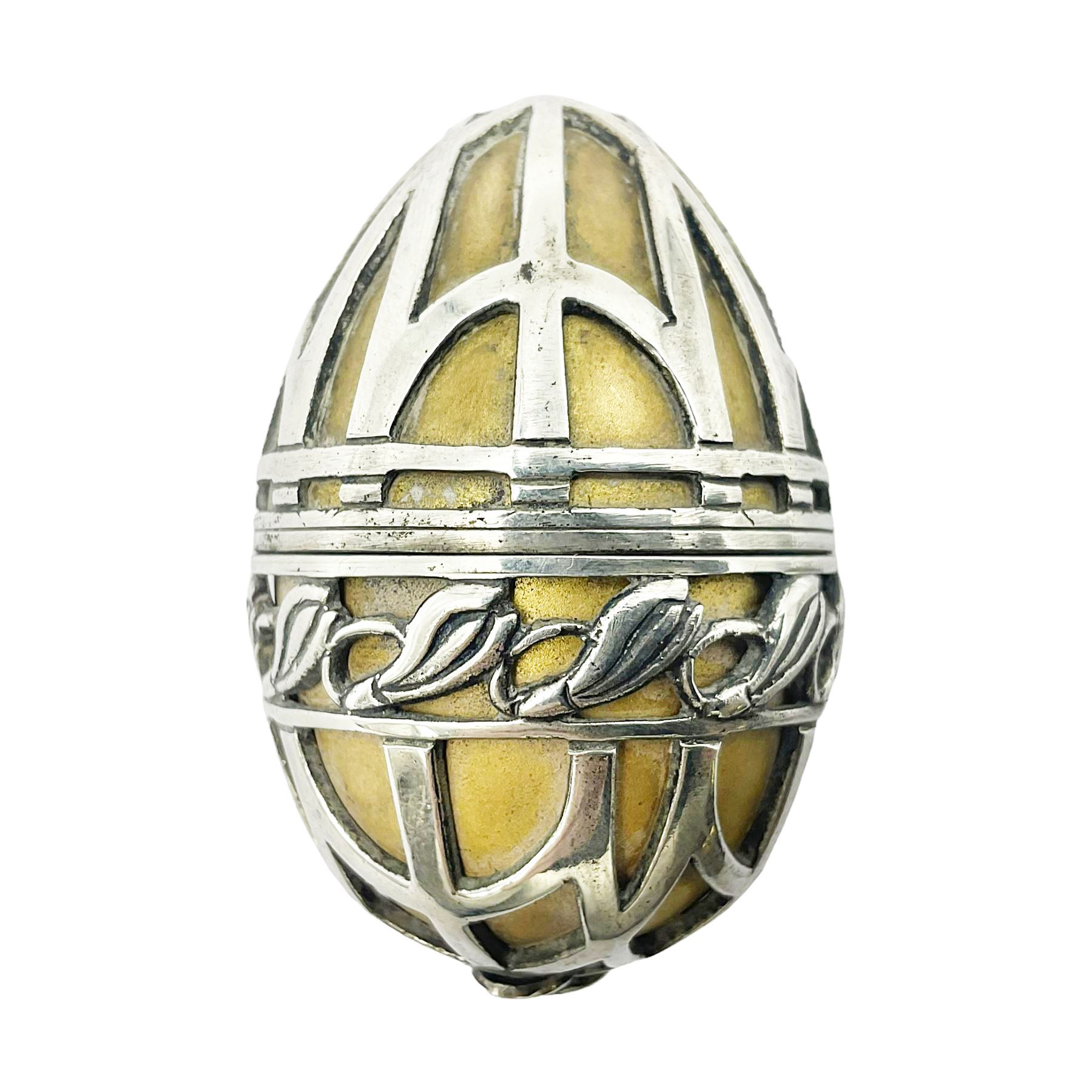 Modern silver limited edition Easter egg, no. 70/500, the gilded body decorated in relief with silver latticework and a band of flower heads, the detachable cover opening to reveal a gilt interior, each hallmarked St James House Company, London 1978, H5.5cm