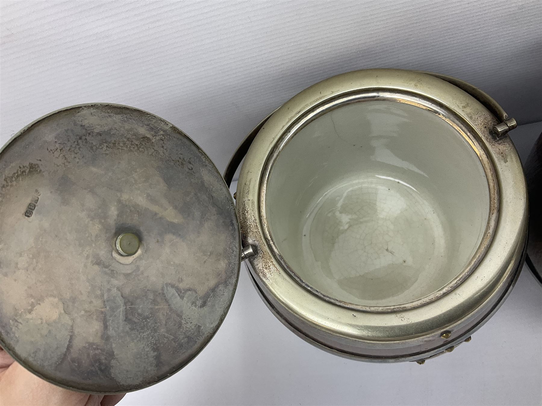 Five early 20th century biscuit barrels with silver-plated mounts