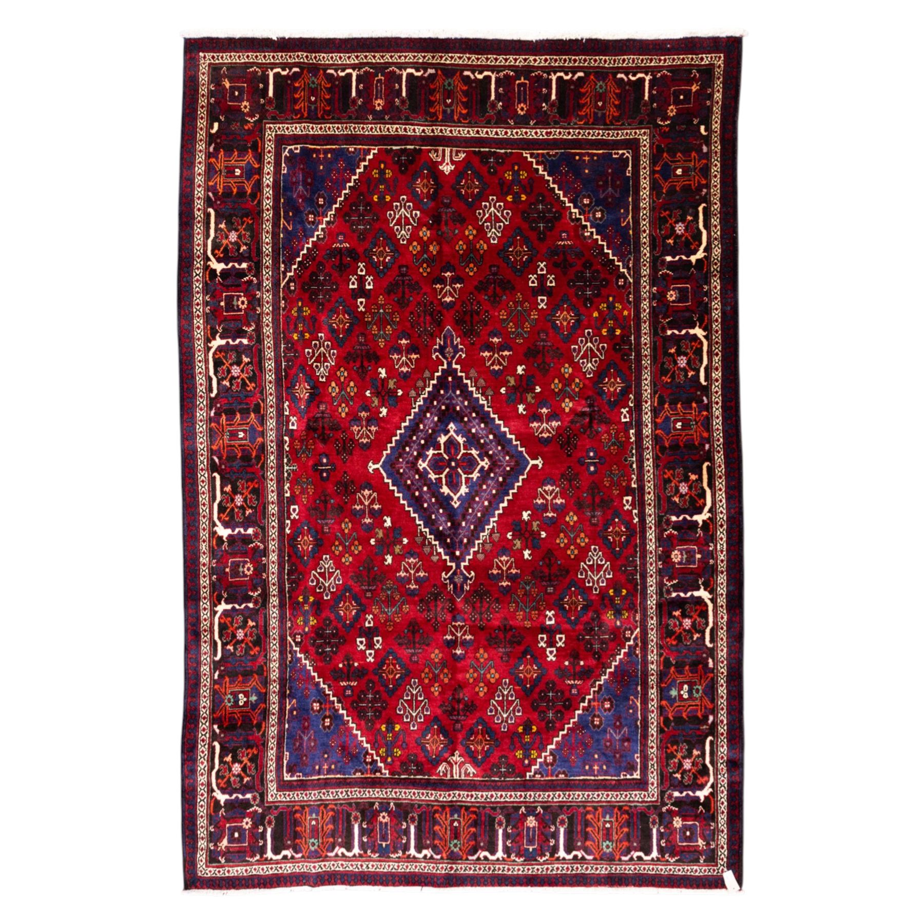 Central Persian Joshagan hand-knotted rug, madder-red field with central stepped lozenge medallion enclosed by angular spandrels, field decorated with repeating stylized geometric floral motifs and small diamond devices enclosed by a dark border of geometric ornament between multiple guard stripes, with cotton fringe ends  