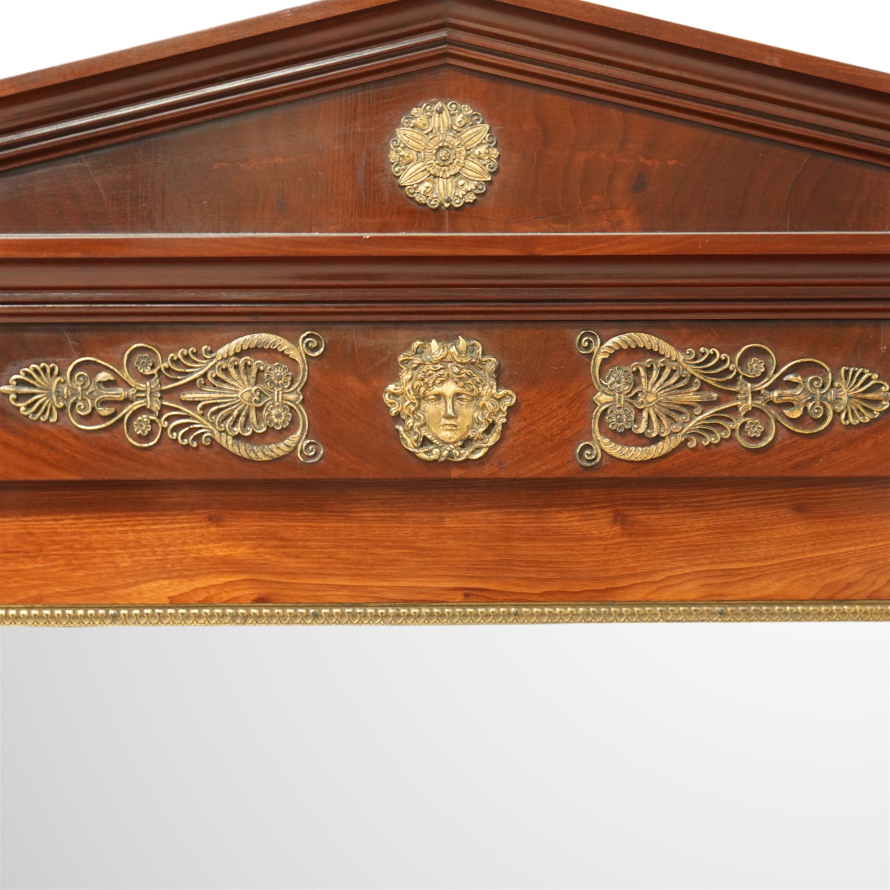 Rare pair of French Second-Empire neoclassical style mahogany mirrors with ormolu mounts, architectural pediment with central ormolu patera above flame mahogany frieze with honeysuckle flower and caryatid mounts, the frame with ormolu beading and bevelled mirror plates, flanked by turned columns with ormolu mounts above a reverse breakfront base, circa 1870