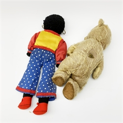 Mid-20th century teddy bear, the plush covered body with applied eyes and nose and stitched mouth, fitted with manual wind musical movement which also turns the head H32cm; and golly with painted features, ear-rings and Romany style costume (2)