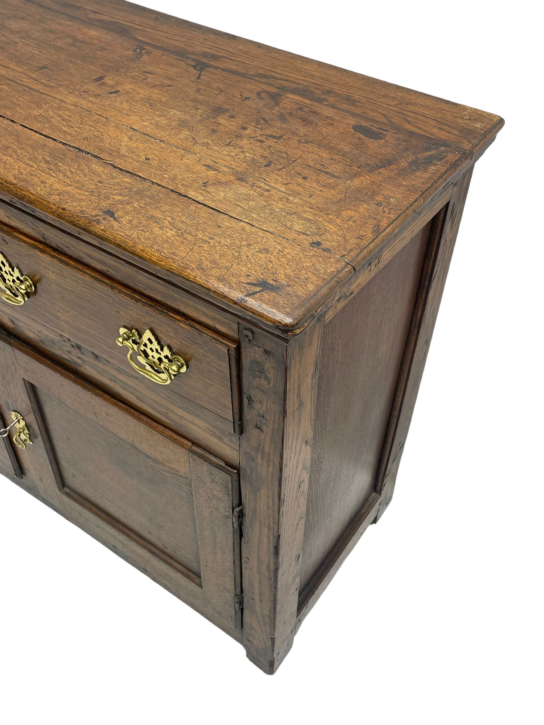 George III country oak dresser base,  rectangular top over with three central drawers flanked by two drawers and two panelled cupboards, each with moulded fronts, on stile feet