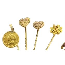 Seven Victorian and later gold stick pins including two hearts, circular diamond, 22ct gold American 1 dollar and horseshoe