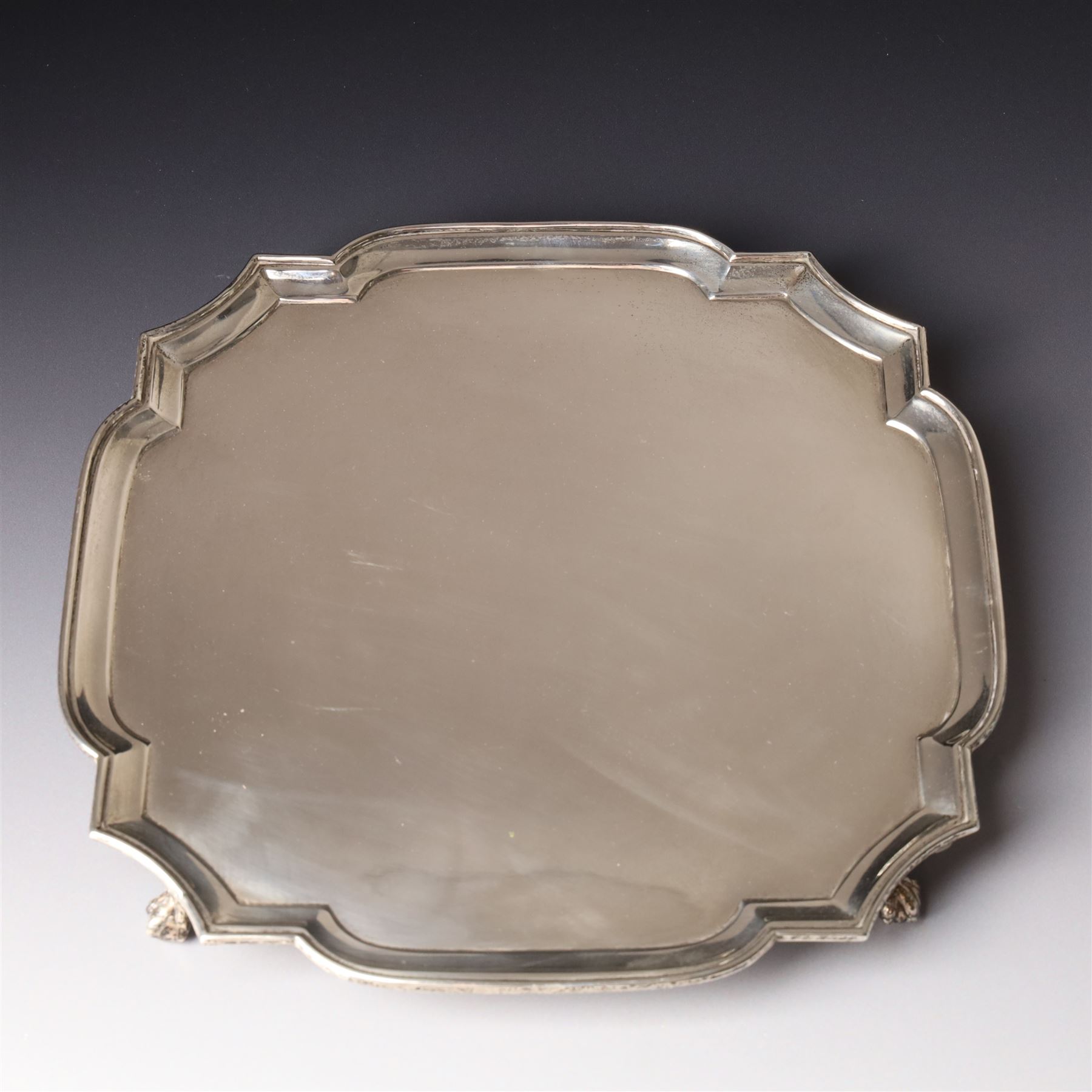 Square silver salver with canted corners and raised border on claw and ball feet 25cm London 1934 Maker Searle & Co Ltd