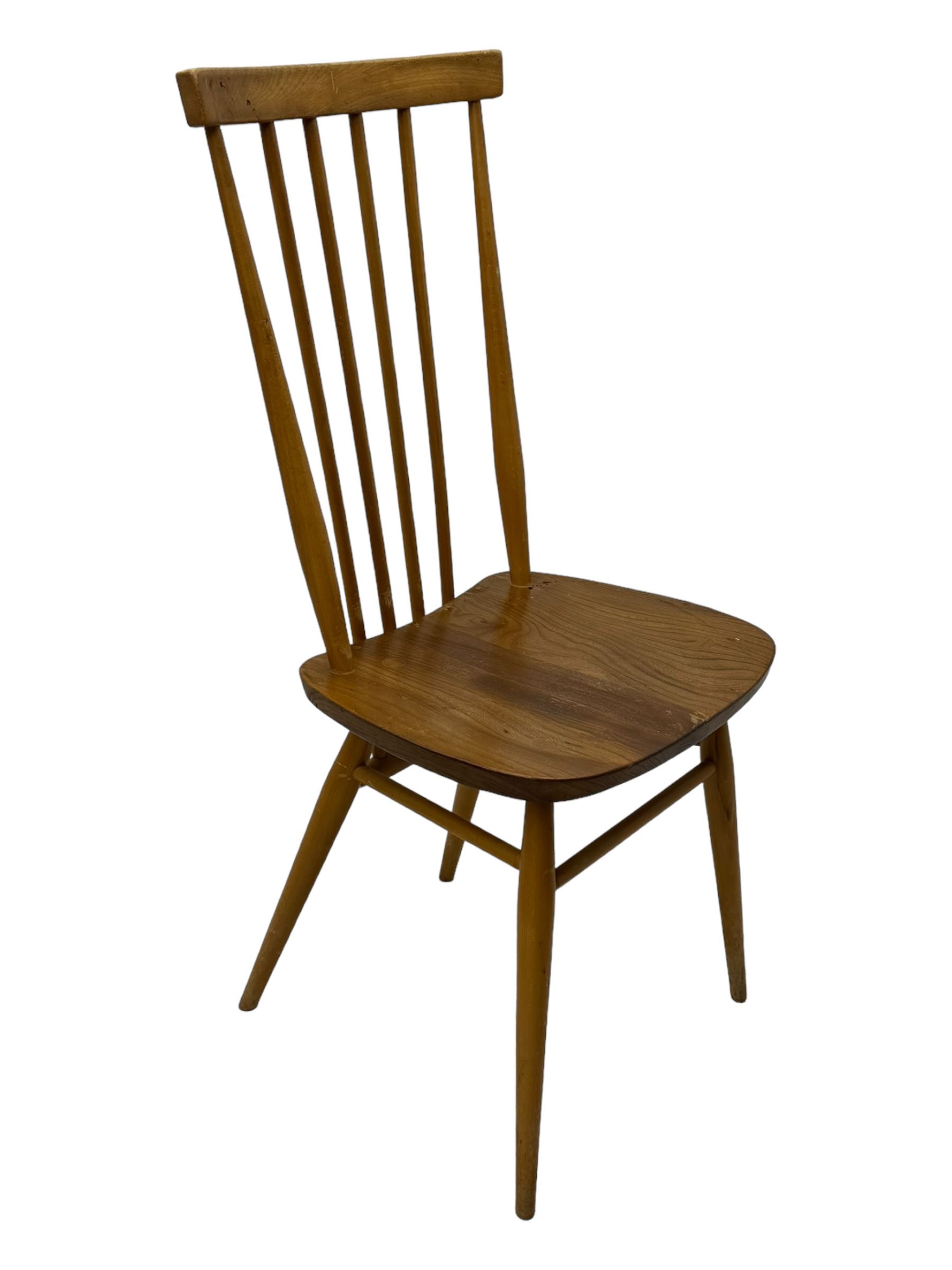 Ercol - pair of mid-20th century highback 'Windsor' chairs, curved top rail over six vertical spindles and shaped seat, on tapering cylindrical supports with stretchers
