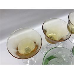 Ten coloured Adriana wine glasses by Abigails, to include blue, green, pink and yellow examples, each with part faceted bowl and twist stems, together with two similar orange examples with pulled stems, H24cm