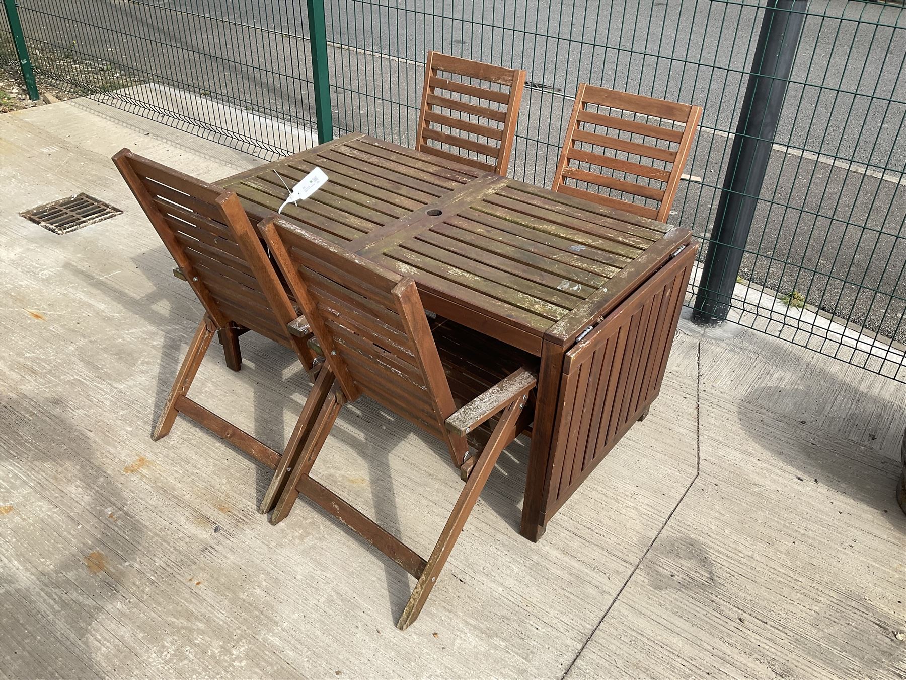 Rectangular teak drop leaf garden table, and four slatted armchairs