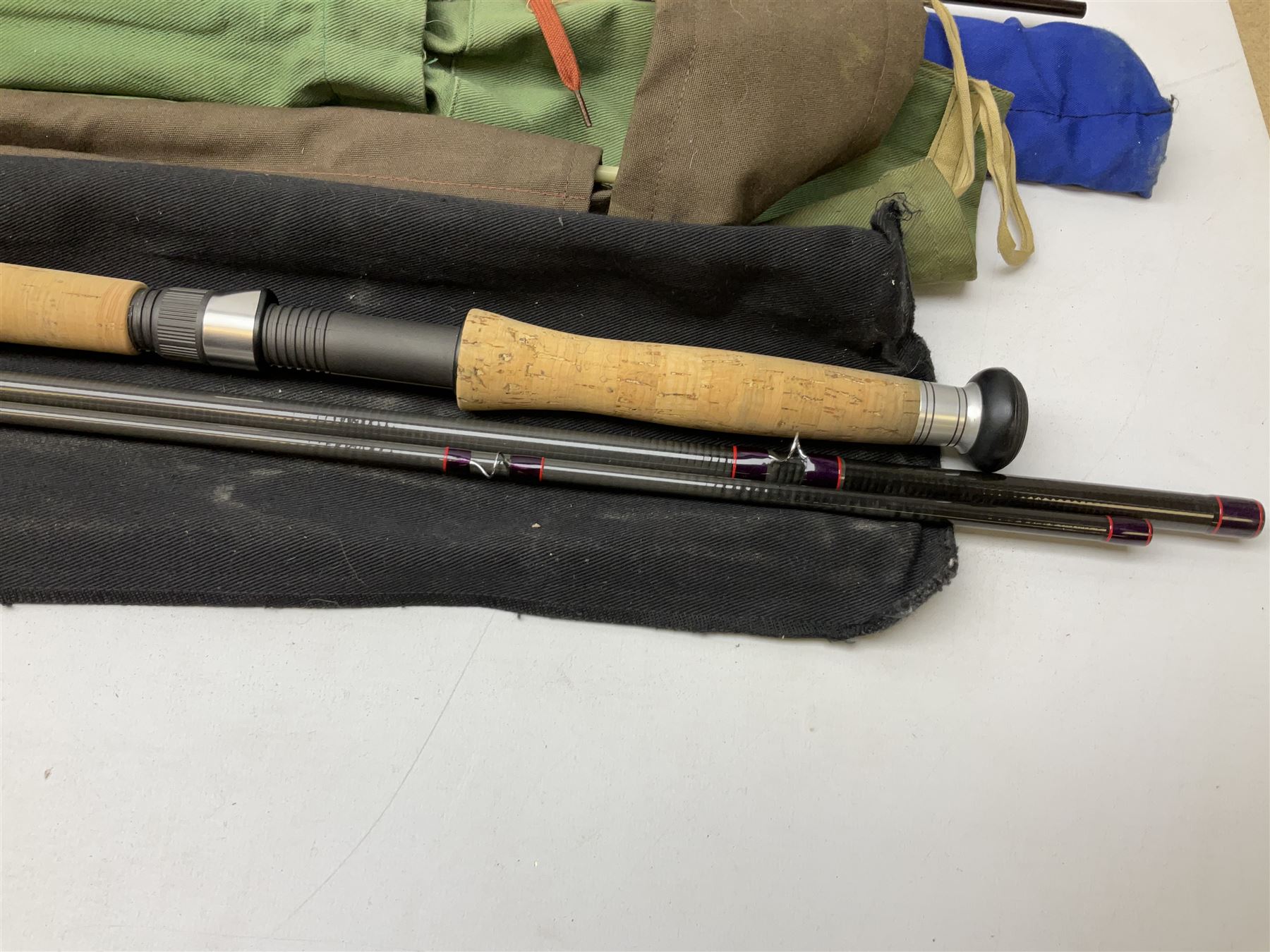 Twelve carbon fiber fishing rods in cloth covers, to include Normark fishing rod, Daiwa Carbon C98 etc (12)
