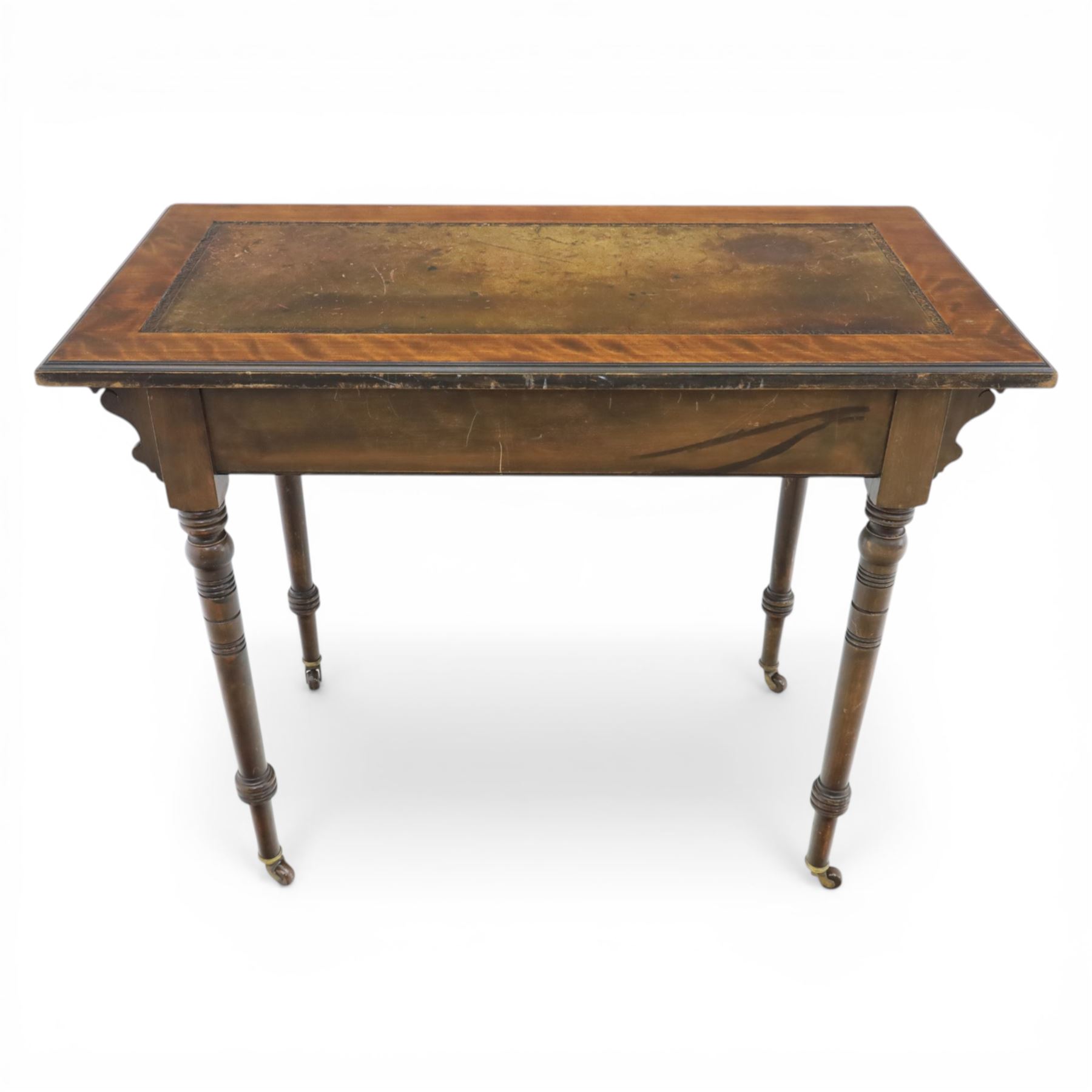 Edwardian mahogany writing table, tooled leather top over two frieze drawers, on turned supports terminating in castors