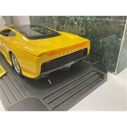 Two Maisto 1:12 scale Jaguar XJ220 ‘Racing’ cars in yellow, both on plinths in original boxes 
