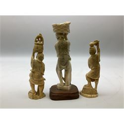 Three Japanese Tokyo School ivory figure, 19th century, comprising of man standing holding double gordes, man holding a flower with a basket on his head and a man with an adze and a basket with a frog in, tallest example H19cm, 