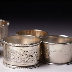 Three engraved silver napkin rings and four others (7)