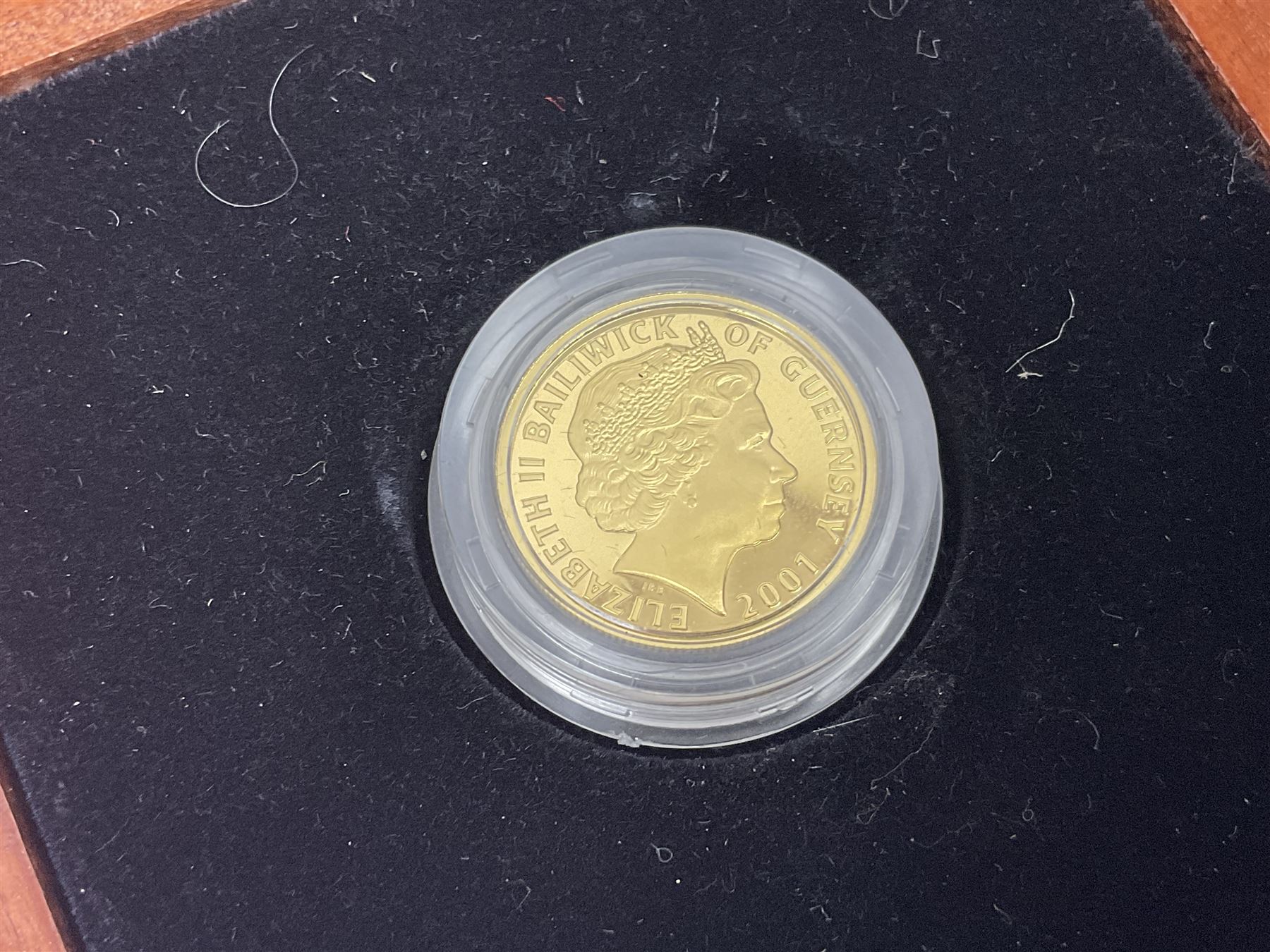 Single owner lifetime collection of mostly commemorative modern World coins with gold, silver and base metal examples, including two Queen Elizabeth II Bailiwick of Guernsey twenty-five pound gold coins 'The 1999 Royal Wedding' and '100th Anniversary of the End of the Victorian Era' 2001 each in 24 carat gold weighing 7.81 grams with certificates, silver coins commemorating the Millennium 2000 including Guyana sterling silver proof two-thousand dollars, Fiji sterling silver proof five dollars etc, silver coins from the Queen Elizabeth II Golden Jubilee Collection dated either 2002 or 2003 from Great Britain and the Commonwealth countries, United Kingdom commemorative crowns in card folders, The Royal Mint United Kingdom 1997 proof coin set in red folder without certificate etc