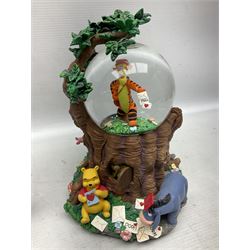 Four Disney Winnie The Pooh snow globes, comprising Pooh Graduation, Valentine, Easter Pooh and Candy Store, together with two water globes comprising Pooh Easter and Hanukah Party, all with boxes (6)