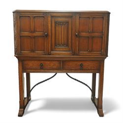 Arts and Crafts oak cocktail cupboard, the rectangular top above three panelled cupboard d...